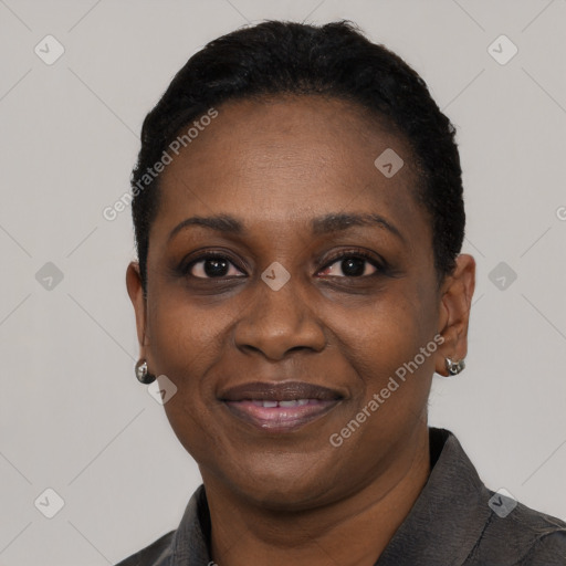 Joyful black adult female with short  black hair and brown eyes