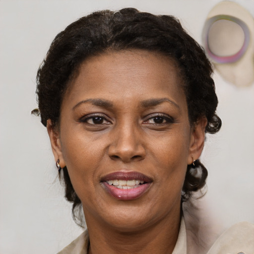 Joyful black adult female with short  brown hair and brown eyes