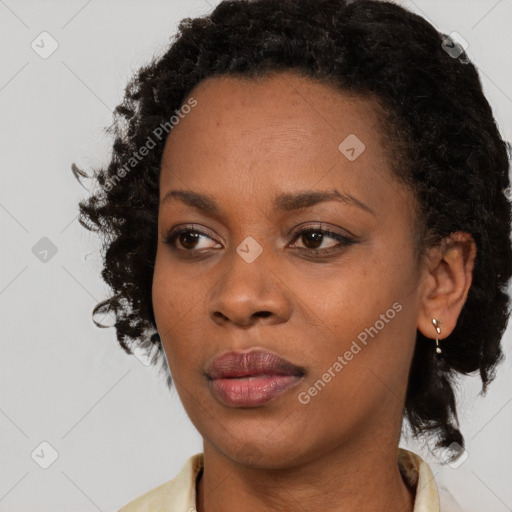 Joyful black young-adult female with medium  brown hair and brown eyes