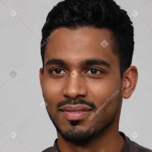 Joyful black young-adult male with short  black hair and brown eyes