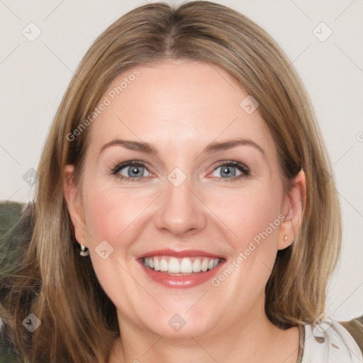 Joyful white adult female with medium  brown hair and blue eyes