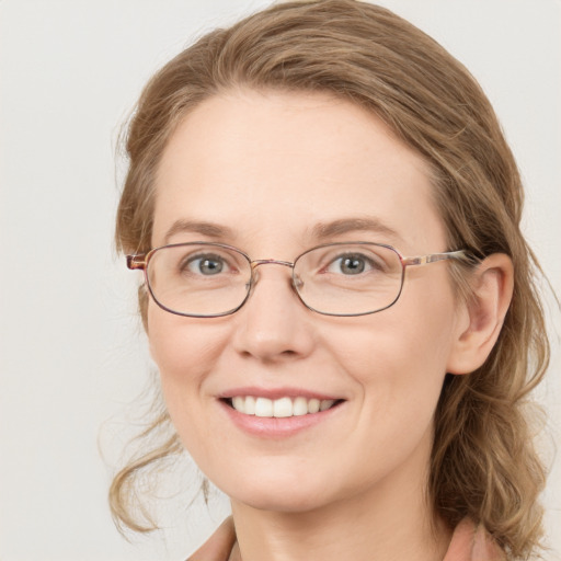 Joyful white adult female with medium  brown hair and green eyes