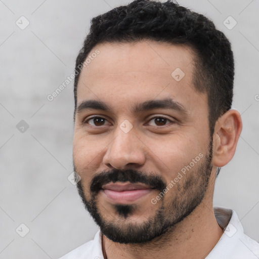 Joyful white young-adult male with short  black hair and brown eyes