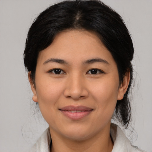 Joyful asian young-adult female with medium  black hair and brown eyes