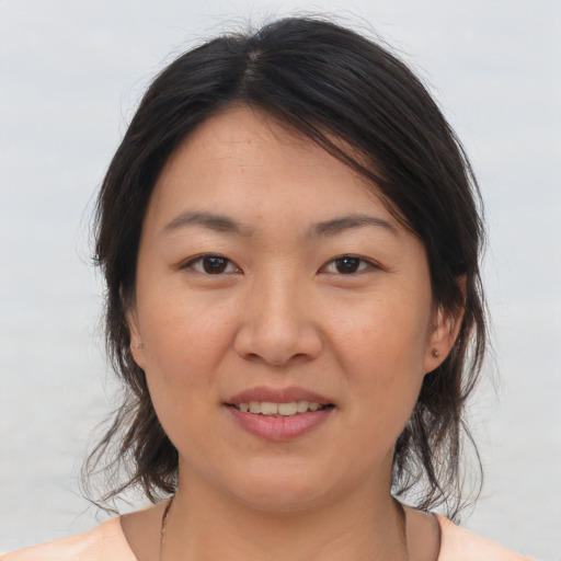 Joyful asian young-adult female with medium  brown hair and brown eyes