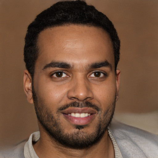 Joyful black young-adult male with short  black hair and brown eyes