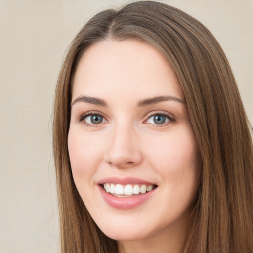 Joyful white young-adult female with long  brown hair and green eyes