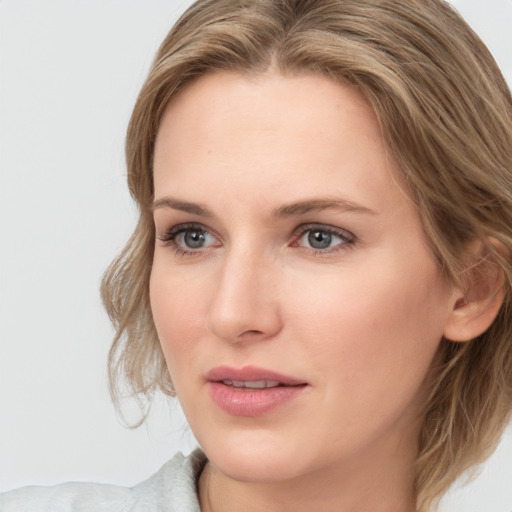 Joyful white young-adult female with medium  brown hair and blue eyes