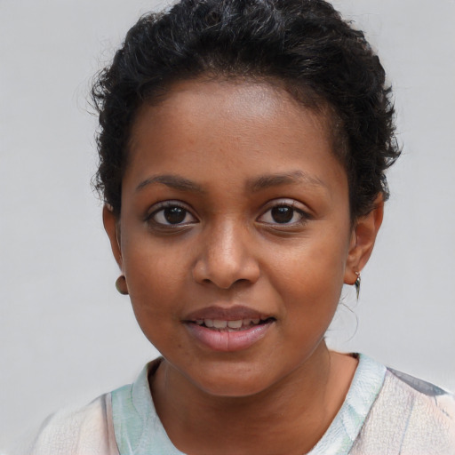 Joyful black young-adult female with short  brown hair and brown eyes