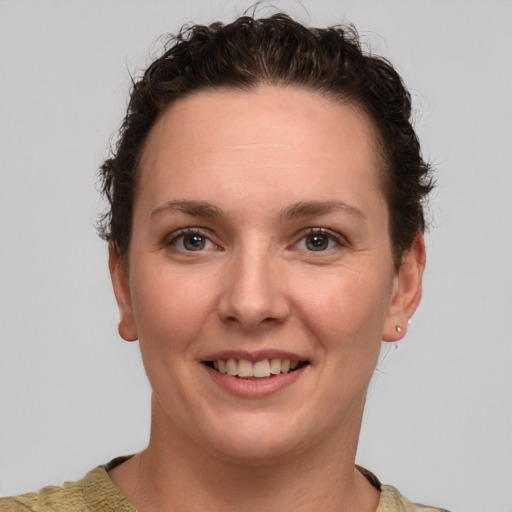 Joyful white adult female with short  brown hair and grey eyes