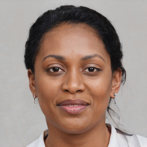 Joyful latino adult female with short  black hair and brown eyes