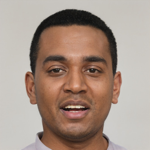 Joyful black young-adult male with short  black hair and brown eyes