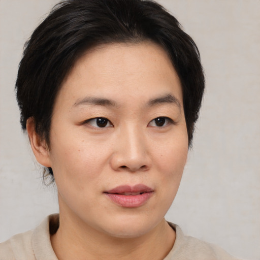 Joyful asian young-adult female with medium  brown hair and brown eyes