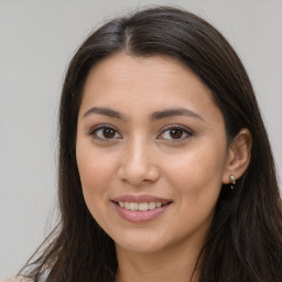 Joyful white young-adult female with long  brown hair and brown eyes