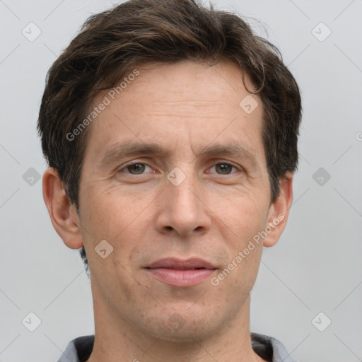 Joyful white adult male with short  brown hair and grey eyes