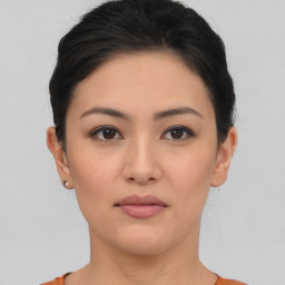 Joyful asian young-adult female with short  brown hair and brown eyes