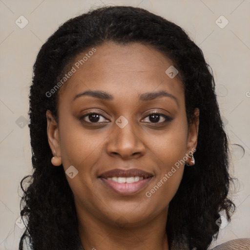 Joyful black young-adult female with long  brown hair and brown eyes