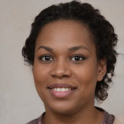 Joyful black young-adult female with medium  brown hair and brown eyes