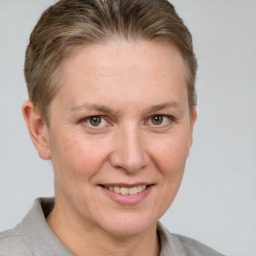 Joyful white adult female with short  brown hair and grey eyes