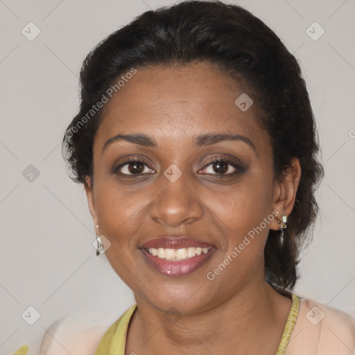 Joyful black adult female with medium  brown hair and brown eyes