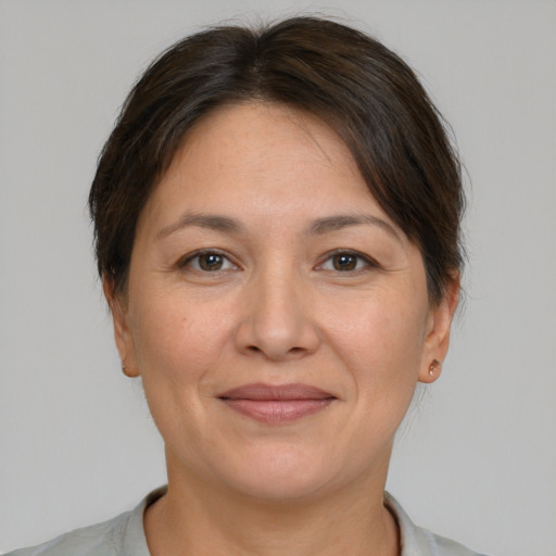 Joyful white adult female with short  brown hair and brown eyes