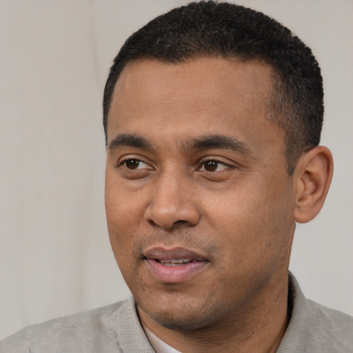 Joyful latino adult male with short  black hair and brown eyes