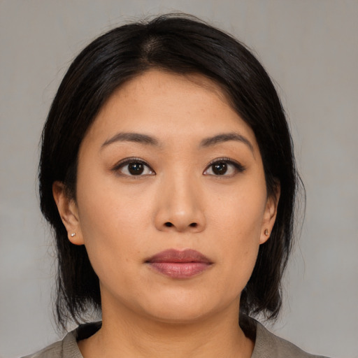 Neutral asian young-adult female with medium  black hair and brown eyes