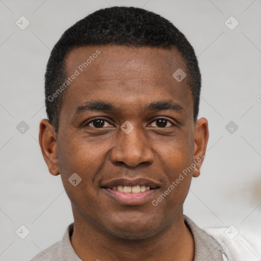 Joyful black young-adult male with short  brown hair and brown eyes