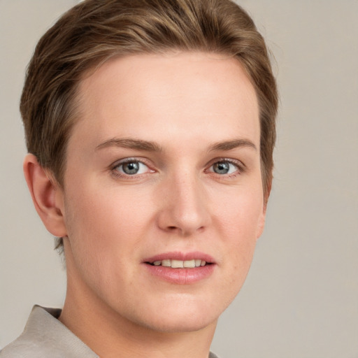 Joyful white young-adult female with short  brown hair and grey eyes