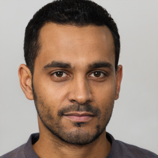 Neutral latino young-adult male with short  black hair and brown eyes