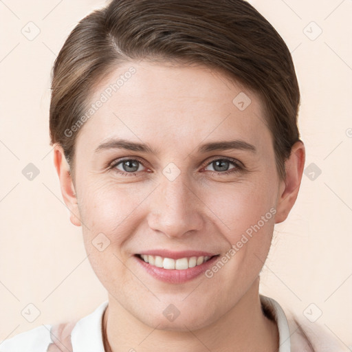 Joyful white young-adult female with short  brown hair and grey eyes