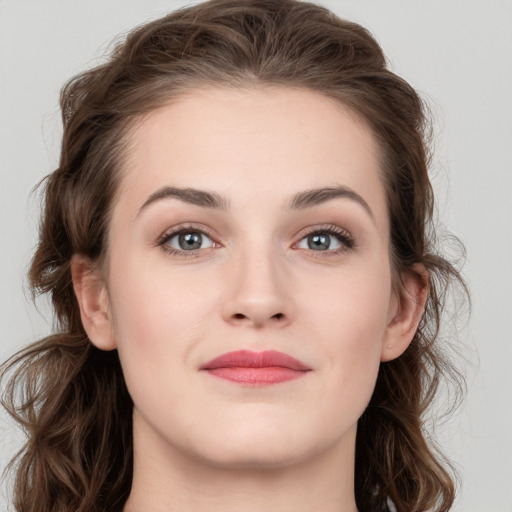 Joyful white young-adult female with medium  brown hair and green eyes