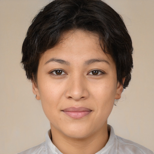 Joyful latino young-adult female with short  brown hair and brown eyes