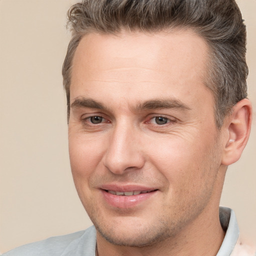 Joyful white adult male with short  brown hair and brown eyes