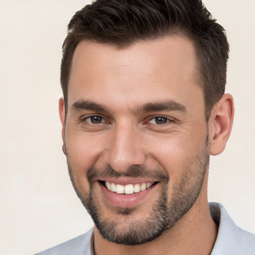 Joyful white young-adult male with short  brown hair and brown eyes