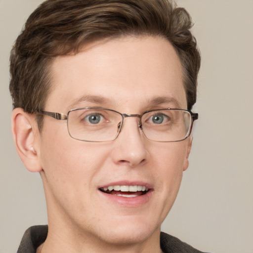 Joyful white adult male with short  brown hair and grey eyes