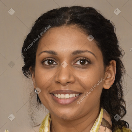 Joyful black adult female with medium  brown hair and brown eyes