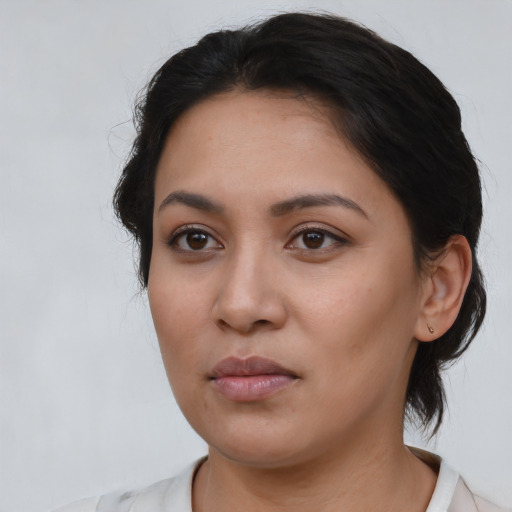 Neutral latino young-adult female with medium  brown hair and brown eyes