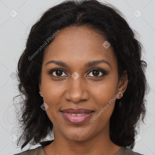 Joyful black young-adult female with long  brown hair and brown eyes