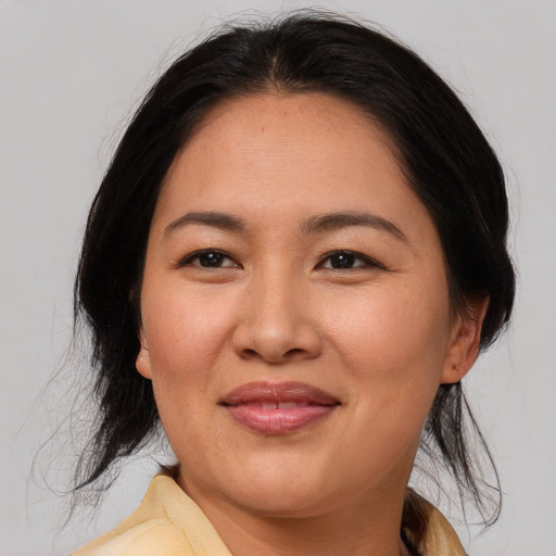 Joyful asian young-adult female with medium  black hair and brown eyes