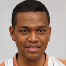 Joyful black young-adult male with short  brown hair and brown eyes