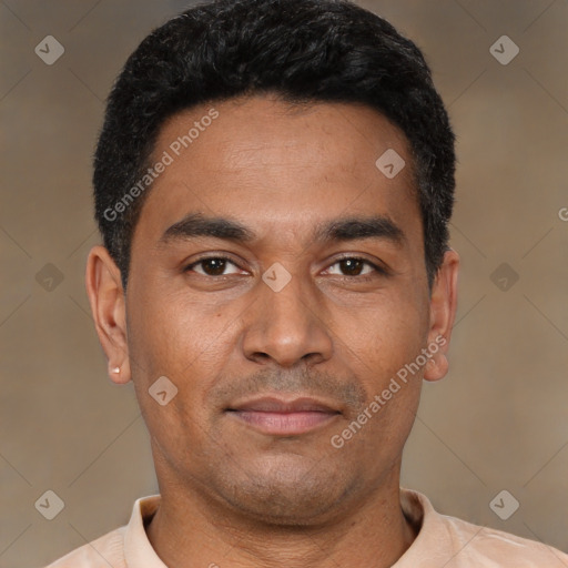 Joyful latino young-adult male with short  black hair and brown eyes