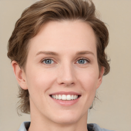 Joyful white young-adult female with medium  brown hair and grey eyes