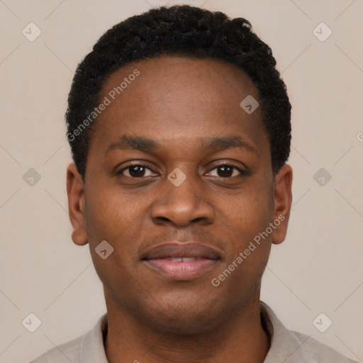 Joyful black young-adult male with short  brown hair and brown eyes