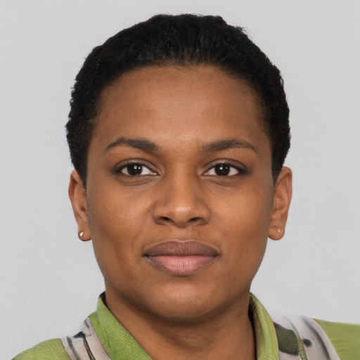 Joyful black young-adult female with short  black hair and brown eyes