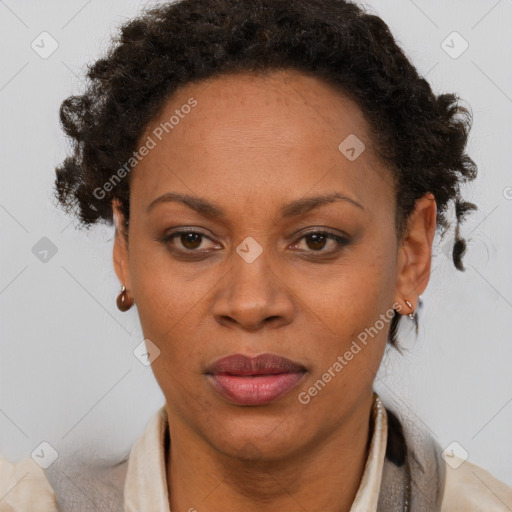 Joyful black adult female with short  brown hair and brown eyes