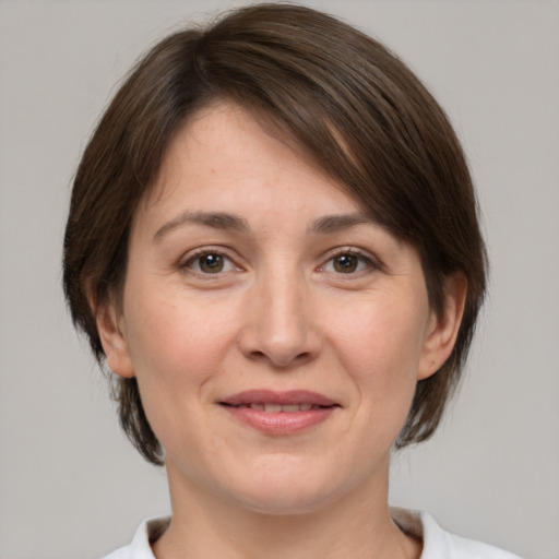 Joyful white adult female with medium  brown hair and brown eyes