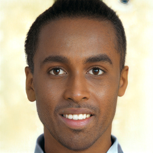 Joyful black young-adult male with short  brown hair and brown eyes