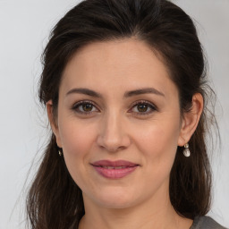 Joyful white adult female with medium  brown hair and brown eyes