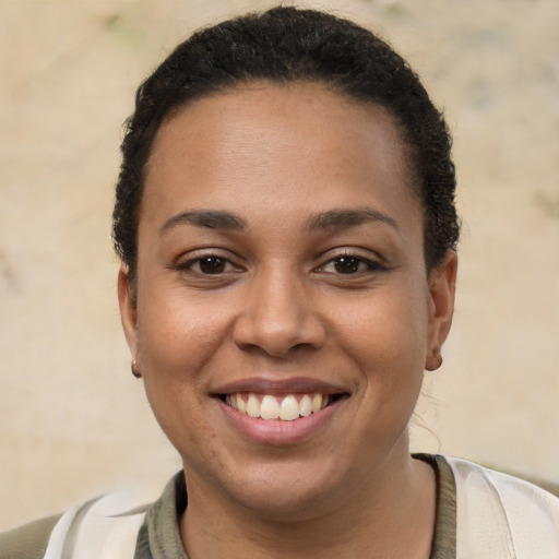 Joyful latino young-adult female with short  brown hair and brown eyes